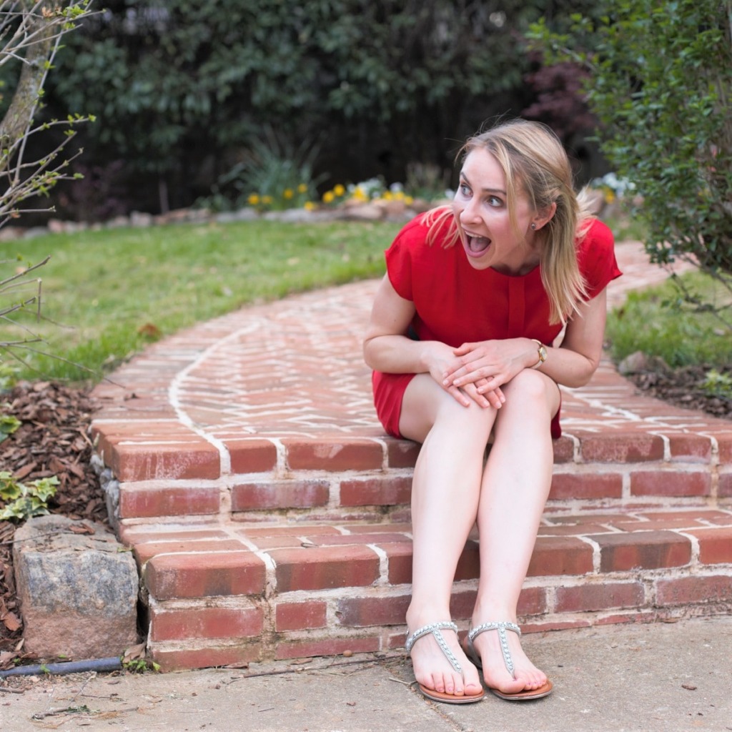 woman in red dress smiling after getting Xeomin vs Botox for the first time to look younger