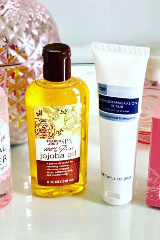 Trader Joe’s top beauty finds and Trader Joe’s beauty products that include Trader Joe’s rose facial oil, Trader Joe’s 100% Pure Jojoba oil, Trader Joe’s microdermabrasion scrub exfoliating cream, and Trader Joe’s rose water facial toner as part of an affordable and cheap skincare routine