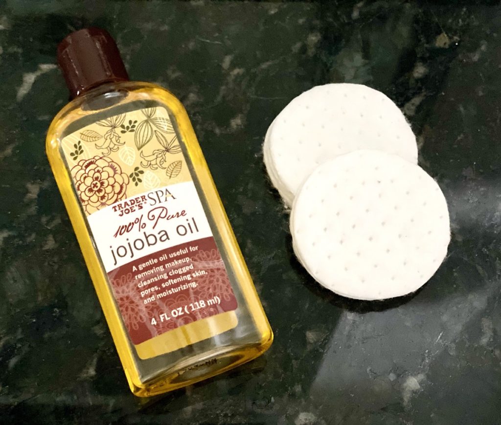 100% pure jojoba oil from Trader Joe's with makeup cotton pad to remove makeup at night without a makeup remover pad