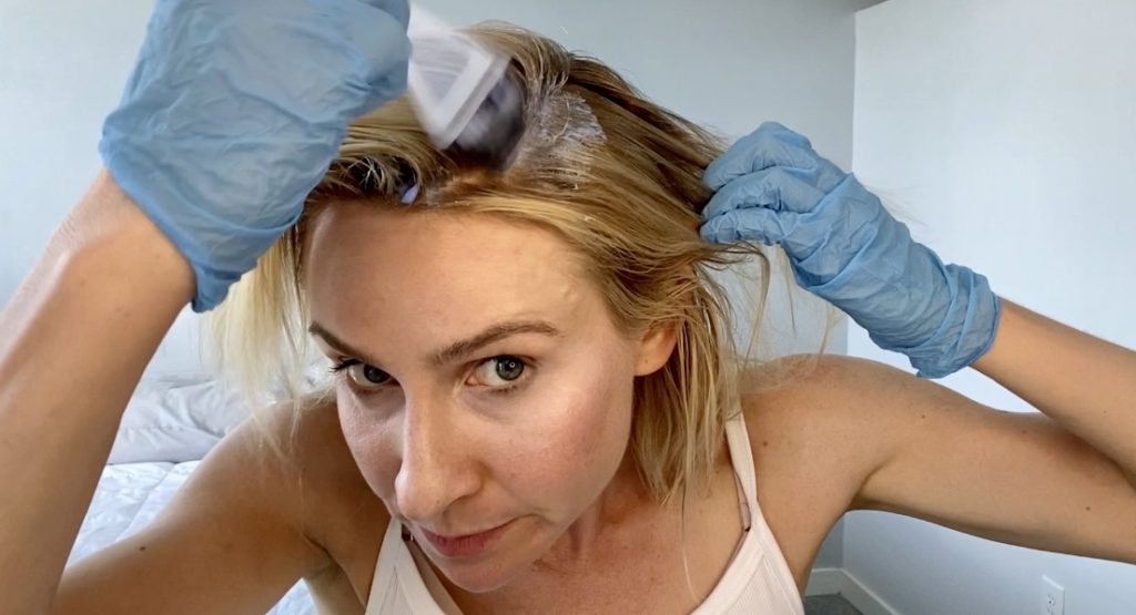 girl applying bleach to hair with prismlights bleach and developer to bleach hair at home