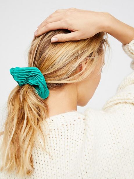 blonde college girl with a green scrunchie as a back to school college gift