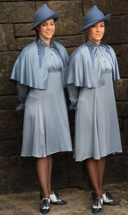 girls from Beauxbatons Academy Dress in Harry Potter in blue hats, blue dresses, tights, and black and white shoes