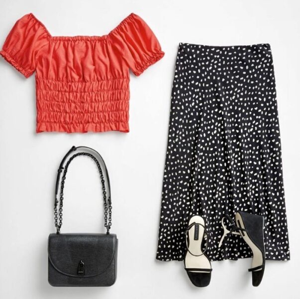 Stitch Fix fall outfit idea and fall outfit with red crop top with ruffles, black and white polka dot skirt, black open toe heels, and medium black purse