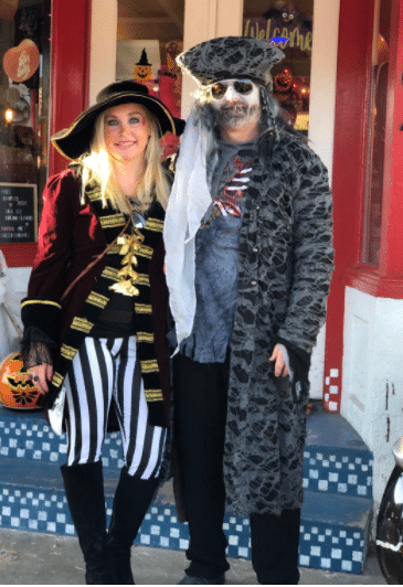 warm and cute pirate and Captain Morgan Halloween costume idea for women with pants and a warm jacket that works as a couples costume idea too