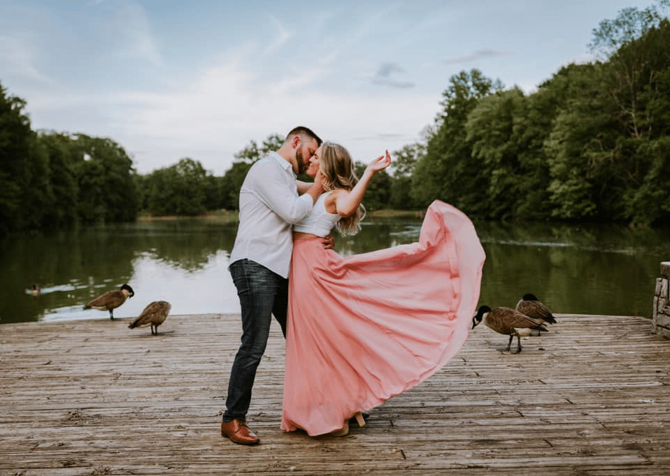 spring outside engagement photo with pink skirt