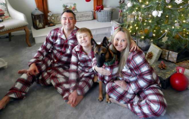 matching Christmas family pajamas with matching dog pajamas in red and white plaid print