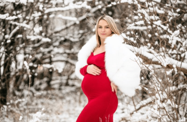 Christmas Maternity Photo Shoot Outside with Snow and Red Dress
