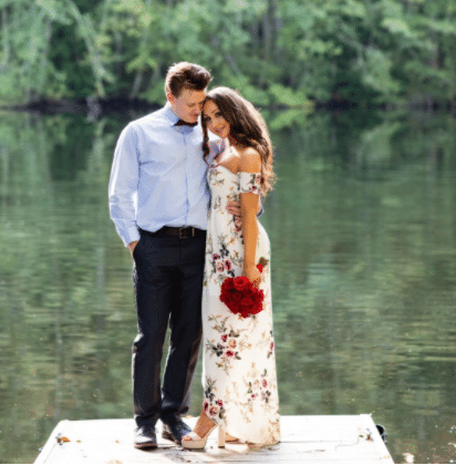 engagement photo idea for summer with girl in flower print dress outside on the lake with fiancee