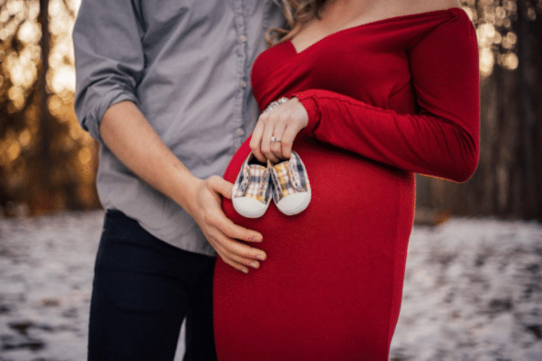 Sweet Maternity Photo Shoot Idea with Red Dress for Christmas and Baby Shoes
