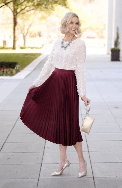 Classy Christmas Party Outfit with Red Pleated Skirt, Gold Heels, and White Blouse