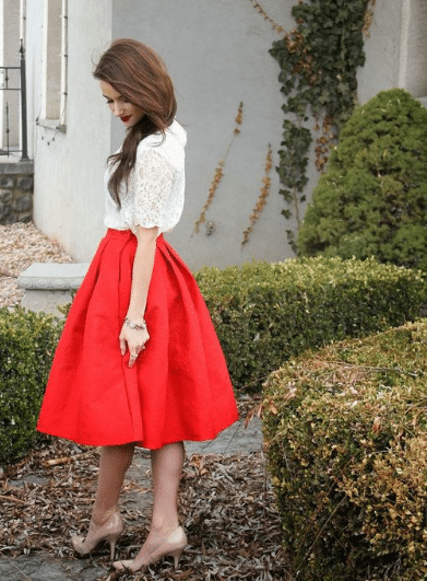 Christmas outfit female with red skirt, lace blouse, and tan heels for Christmas outfit idea for women