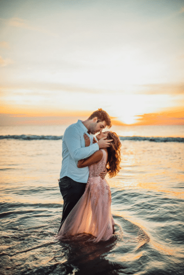 Beach Engagement Photoshoot Idea in the Water with Pink Dress
