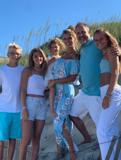family beach photoshoot idea with white and light green and turquoise outfits