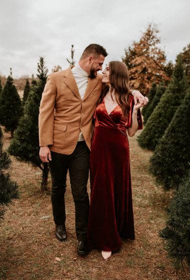 fall and winter engagement photo idea outside with a red velvet dress