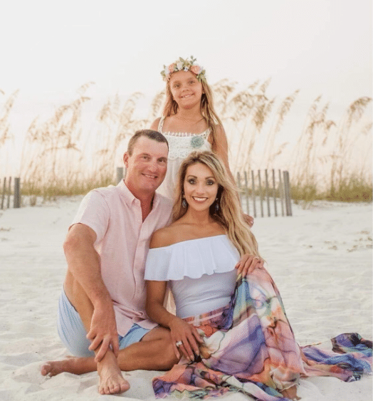 outdoor beach family photo idea with coral, pink, and white outfits