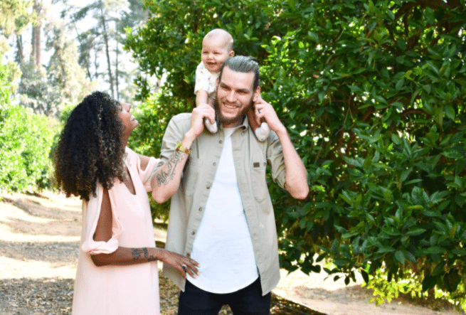 outdoor family outdoor picture idea with black woman, white man, baby, and mixed couple