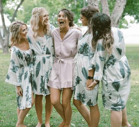 light pink and green tropical leaf bridesmaid robes in satin and silk