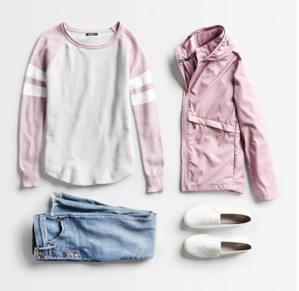 Stitch Fix Spring 2022 Outfit with Pink and Gray Shirt, Pink Rain Jacket, Light Jeans, and White Sneakers
