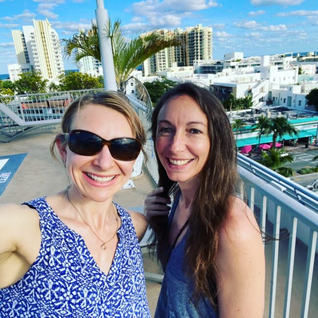 two hot brunette girls in Miami with Jim Maui sunglasses on rooftop 