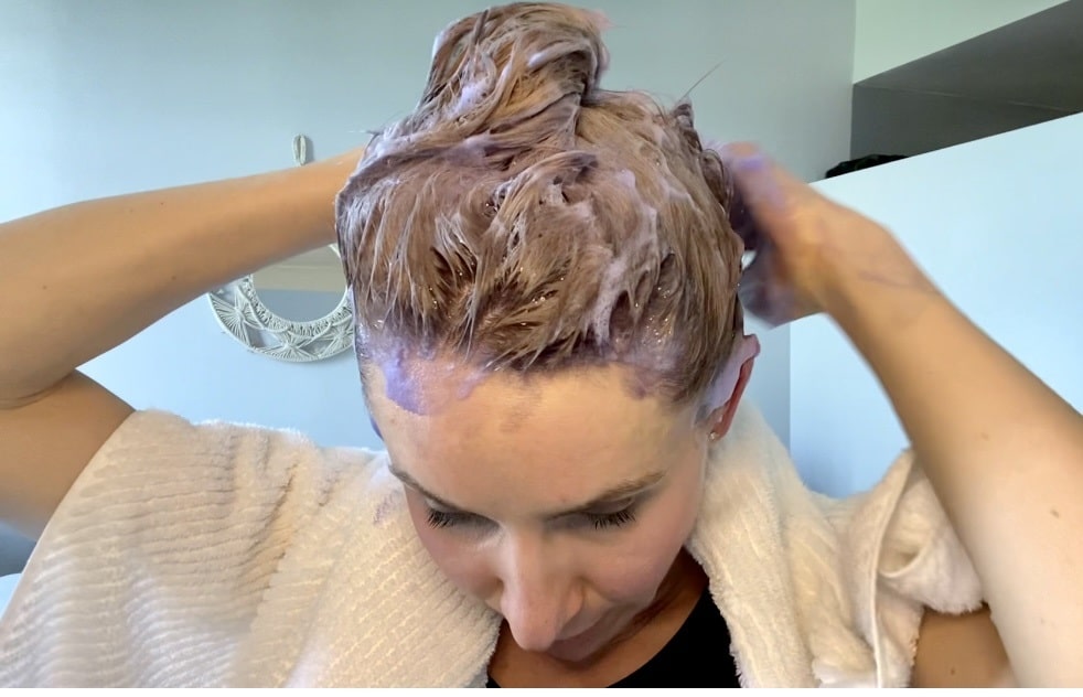 Blonde Applying Fanola No Yellow Purple Shampoo