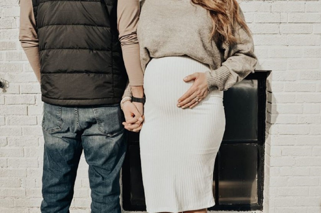 maternity photoshoot for spring with white skirt and sweater for spring maternity outfit