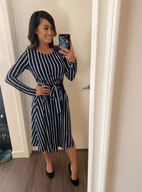 LEVACA striped navy blue nd white midi dress with belt, pockets, and long sleeves on a woman for work