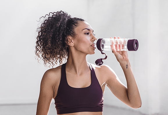 girl drinking water for clear skin and to look younger than her age