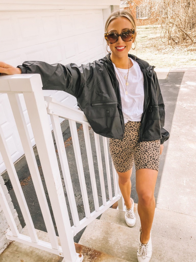 summer leopard print outfit idea with biker shorts, white t-shirt, and black jacket