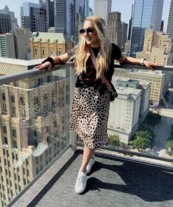 fall outfit with leopard print skirt, sneakers, and t-shirt