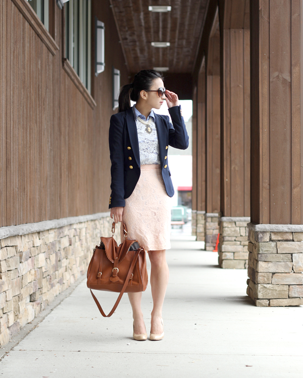 business professional work outfit for spring with pink lace skirt, navy blazer, and nude heels on Asian woman