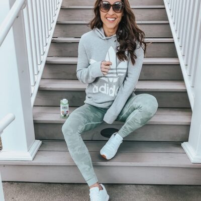 cute athleisure outfit for women with camo leggings white sneakers, and white sneakers