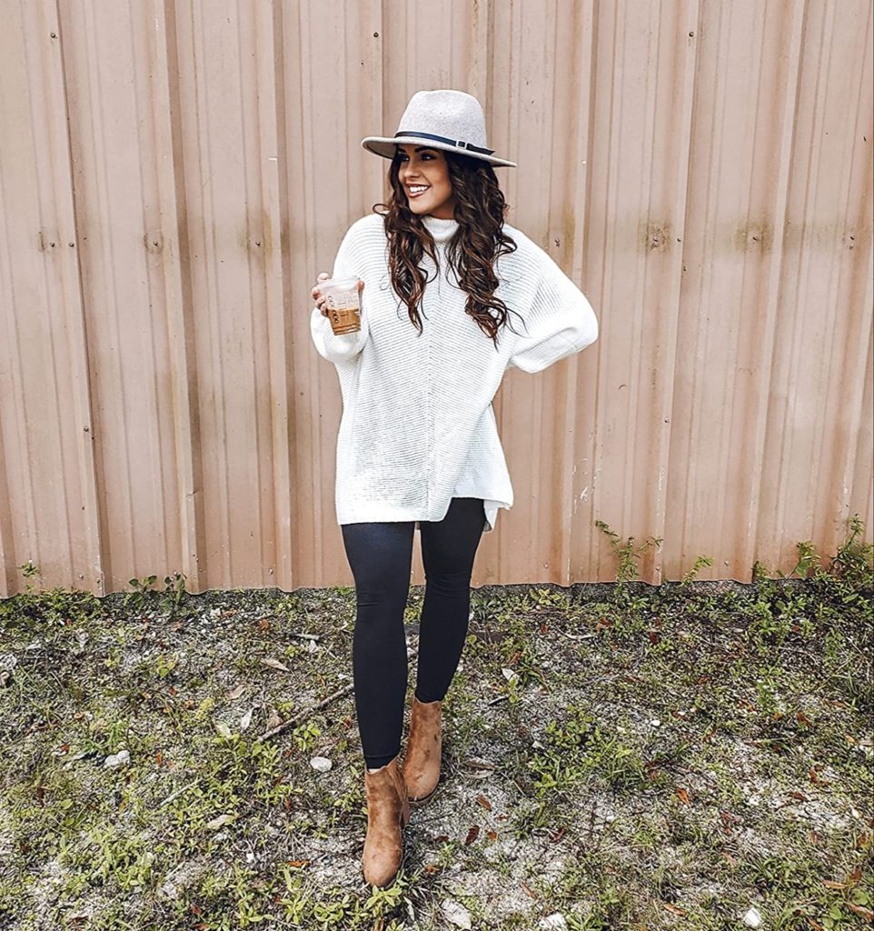 fall outfit idea with white sweater, hat, booties, and black leggings on Amazon