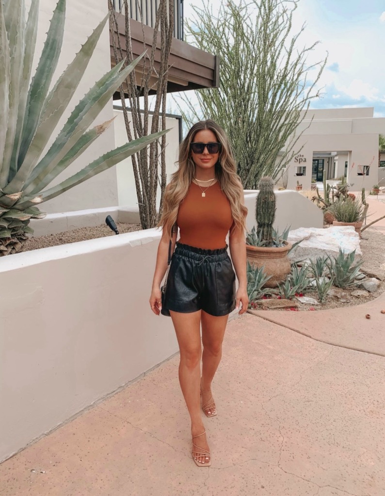 fun neutral colored summer outfit idea with black faux leather shorts and bodysuit on Amazon