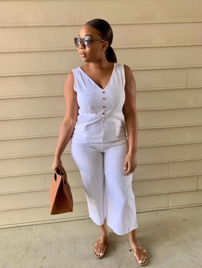 white jumpsuit outfit on black woman with matching tan heels and brown purse