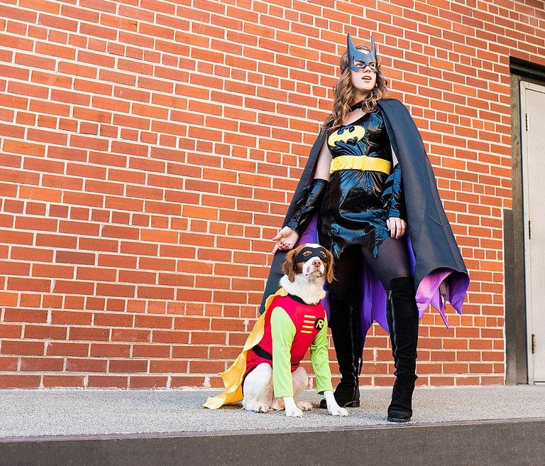 Batgirl and Batman matching Halloween costumes for owner and dog