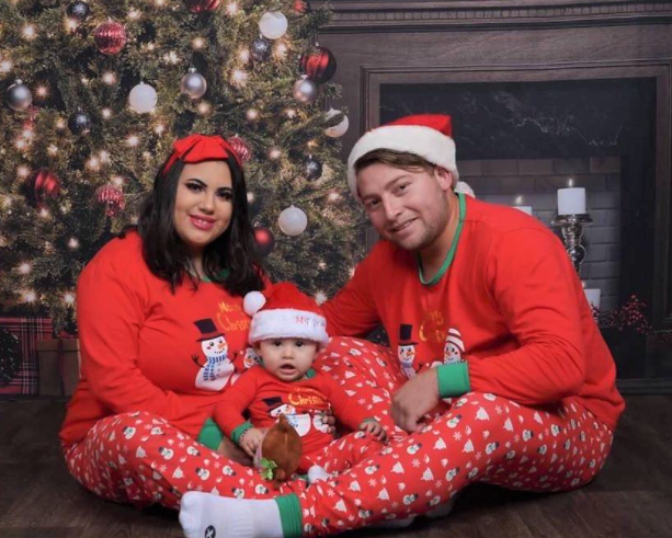 Christmas matching pajamas of couple with baby and snowman pajamas