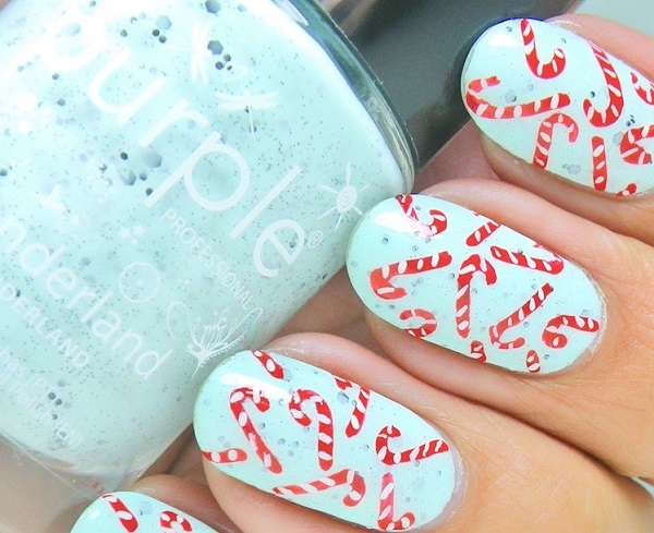 mint green nails with candy canes for fun winter and Christmas holiday nail idea