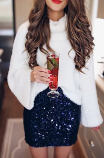 Christmas and holiday party outfit with a blue sequin skirt and a white sweater