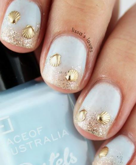 cruise nail designs with light blue nail polish and seashells