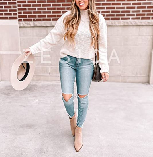 winter outfit idea with chunky cream sweater and jeans