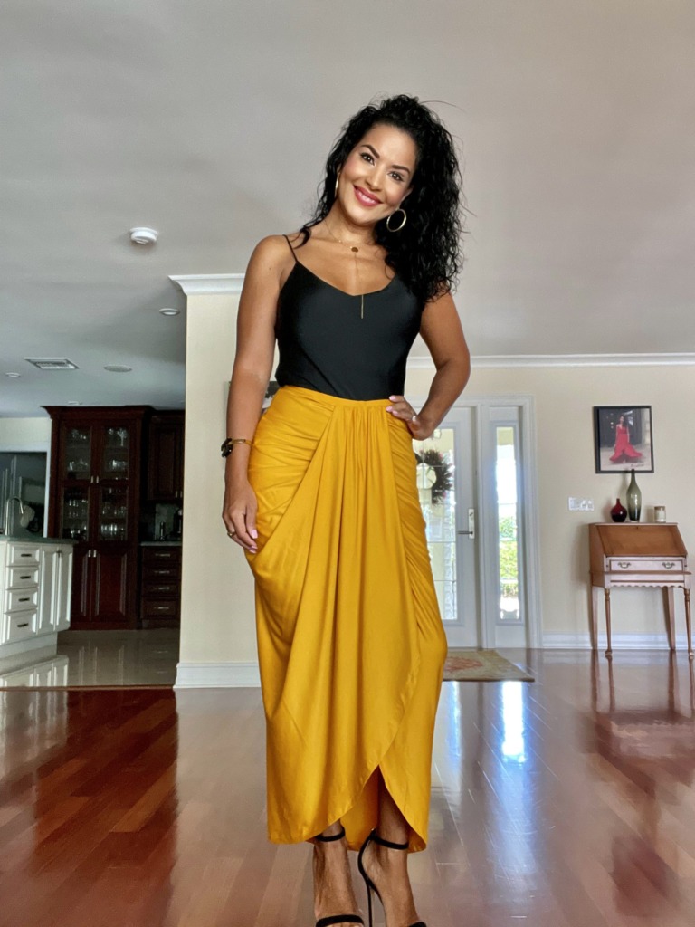 African American black woman in yellow skirt and tank top for vacation outfit