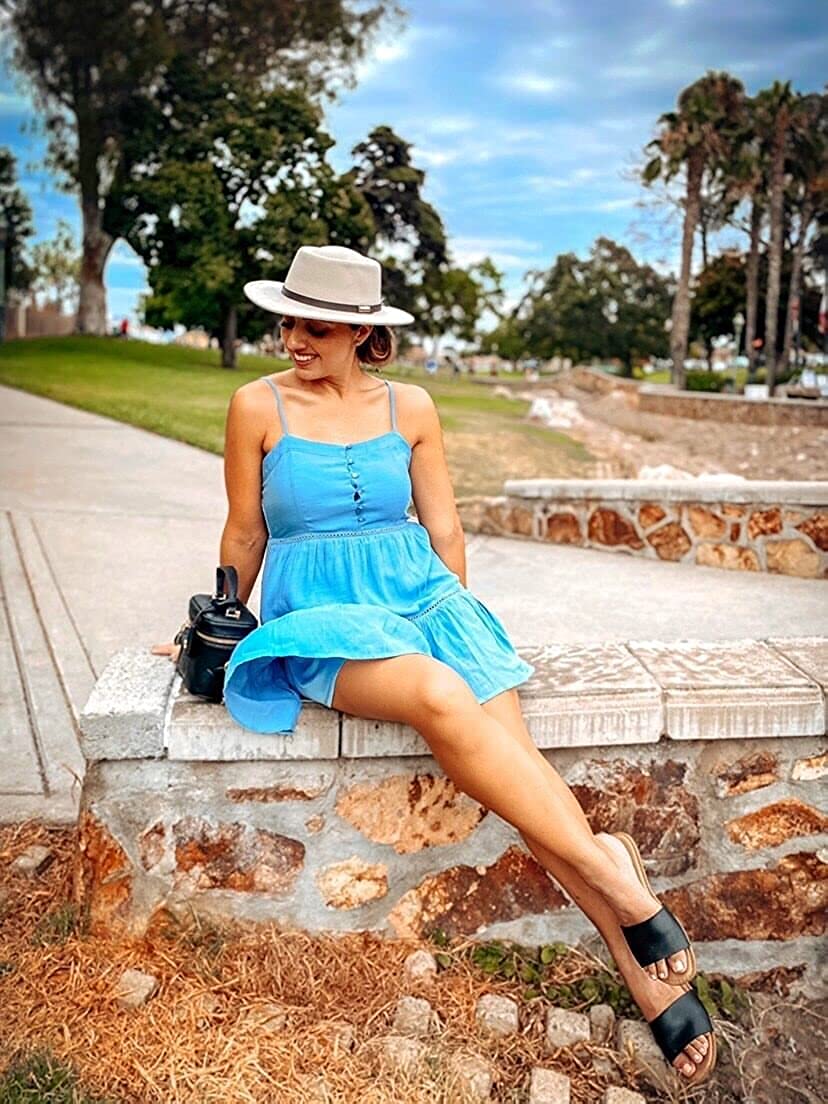 woman in summer Fedora hat and blue dress