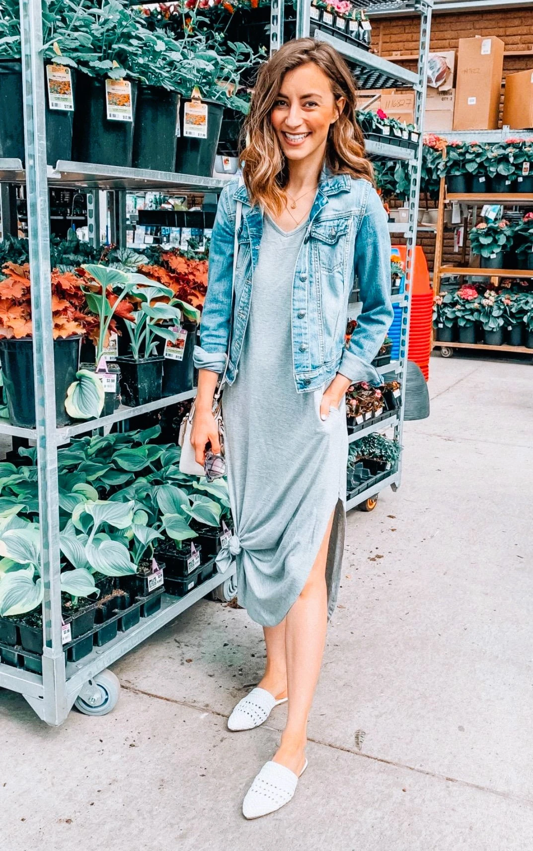 spring or summer outfit with grey maxi dress, jean jacket, and white sneakers