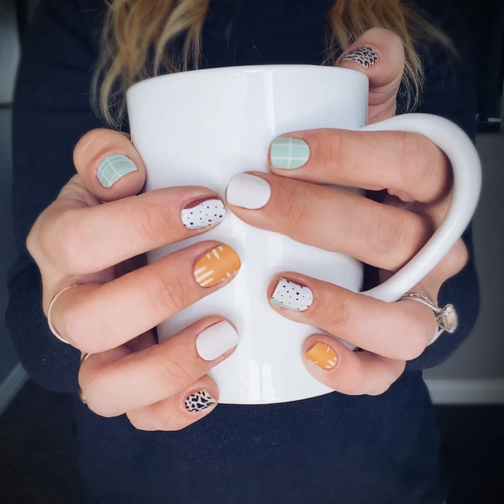 short fall nail designs with teal, orange, and white