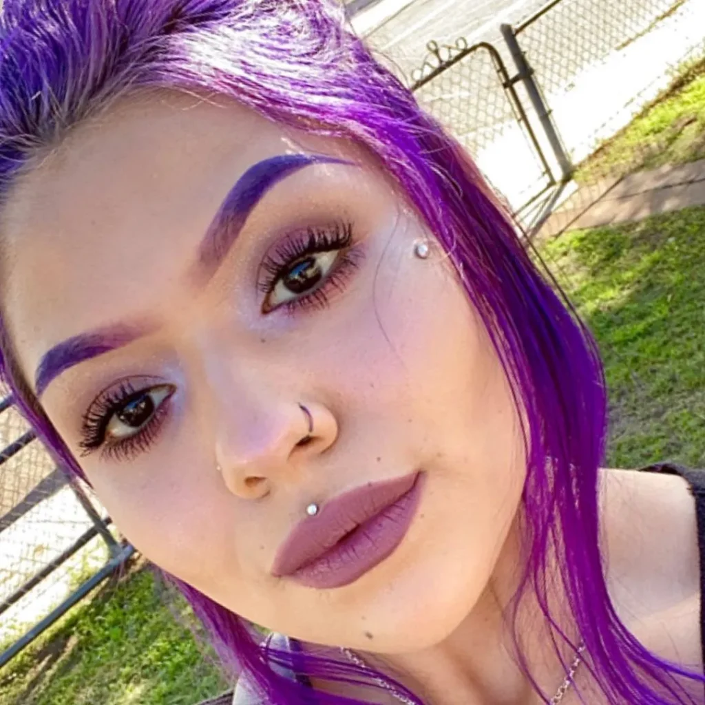 vibrant purple hair with purple eyebrows